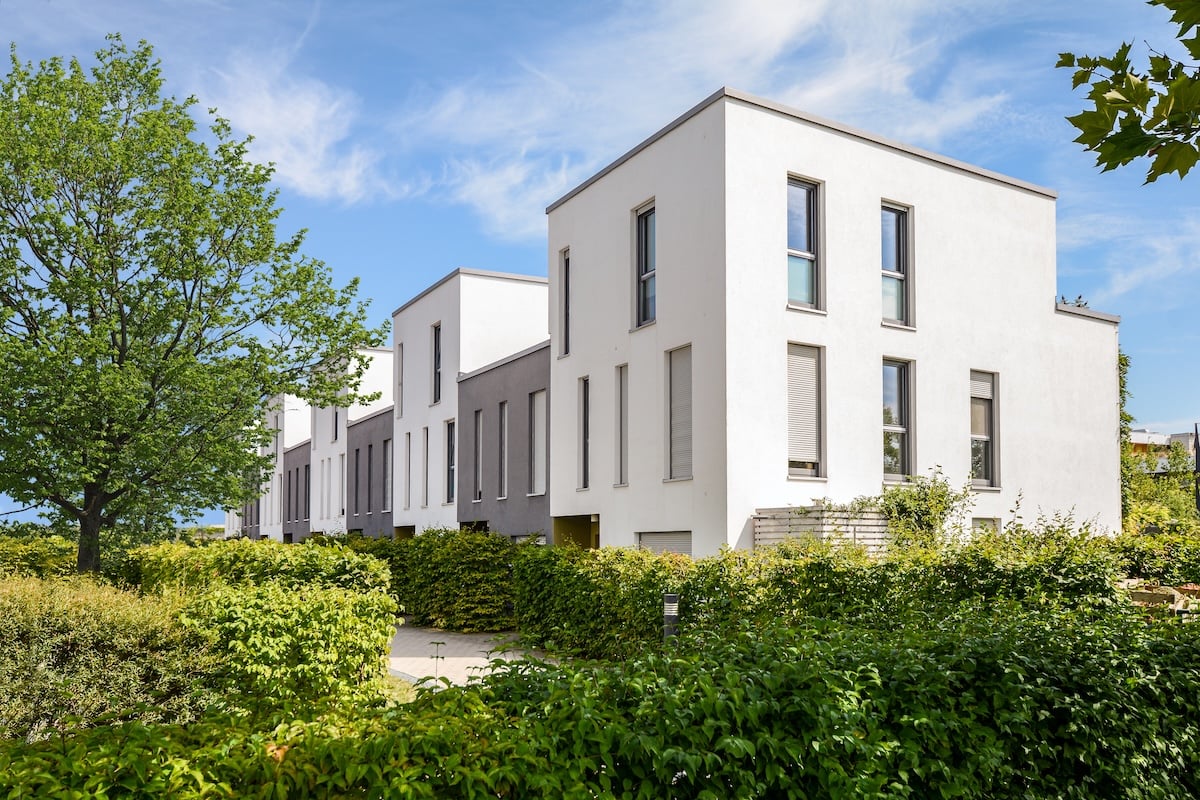 Modern townhouses in a residential area, new apartment buildings with green outdoor facilities in the city