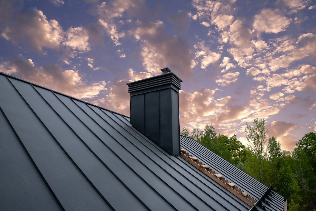 Modern metal chimney on the roof for ventilation standing seam metal roof