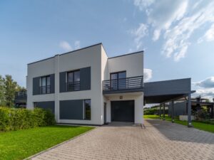 Exterior of modern luxury private house. Garage entrance. Canopy. Blue sky. Sunny day.