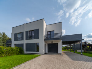 Exterior of modern luxury private house. Garage entrance. Canopy. Blue sky. Sunny day.