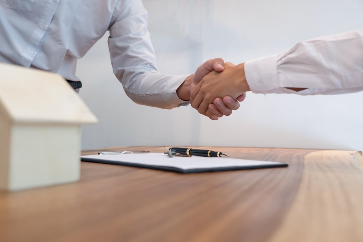 Business people signing contract making deal with real estate agent Concept for consultant and home insurance financing