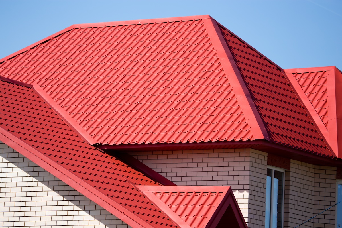 roof with a window in a brick house .