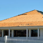 Damaged house roof with missing shingles after hurricane Ian in Florida. Consequences of natural disaster. Damaged house roof with missing shingles after hurricane Ian in Florida. Consequences of natural disaster.