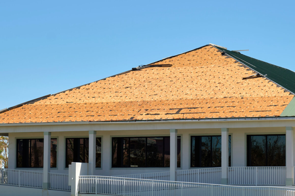 Damaged house roof with missing shingles after hurricane Ian in Florida. Consequences of natural disaster. Damaged house roof with missing shingles after hurricane Ian in Florida. Consequences of natural disaster.