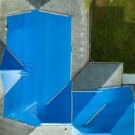 roof insurance claim blue tarping roof after storm